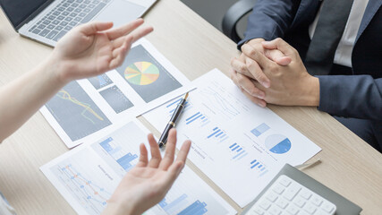 Brainstorm team, Marketers and financial accountants are discussing and analyzing charts to plan strategies to meet customer needs, Team meetings or business consulting.