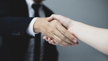 Business personage handshake, Asian business women congratulate on being a corporate partnership with European male investors, Friendship, Sign language greetings, Successful business negotiations.