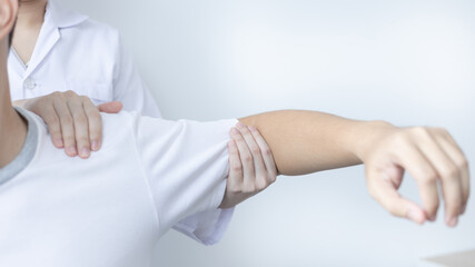Physical therapy, Female physiotherapist treats arms and shoulders pain for a male patient...