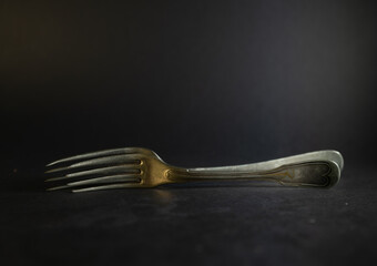 Old silver forks on differtnt background
