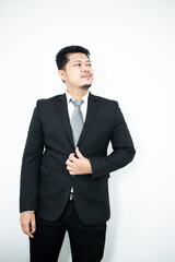 Portrait of a handsome businessman in a black suit and gray tie.
in the white background