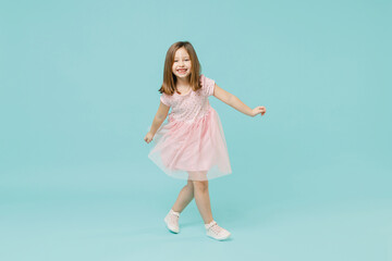 Full size body length little fun cute kid girl 5-6 years old wears pink dress dancing isolated on...