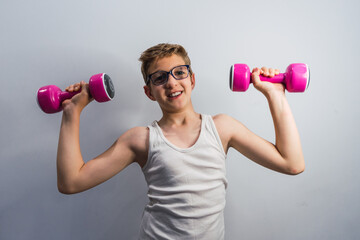 blond boy exercising with pink dumbbells