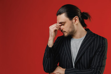 Young puzzled confused businessman latin man 20s long hair ponytail wearing black striped jacket...