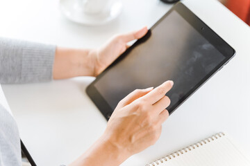 Close up of young women using digital tablet for working in the office.