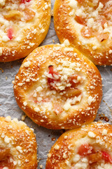 Homemade yeast sweet buns with rhubarb and crumble, top view. 