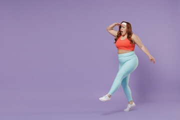 Full length young chubby overweight plus size big fat fit woman in top warm up training hold hand forehead look far away distance go isolated on purple background gym Workout sport motivation concept