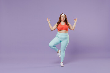 Full length calm young chubby overweight plus size big fat fit woman wear red top warm up training spreading hands in yoga om gesture meditate isolated on purple background gym. Workout sport concept.