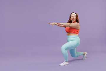 Full length side view young chubby overweight plus size big fat fit woman in red top warm up train squating lunges with legs isolated on purple background home gym. Workout sport motivation concept. - obrazy, fototapety, plakaty