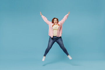 Full length young joyful smiling redhead chubby overweight woman 30s wearing in pink shirt jeans...