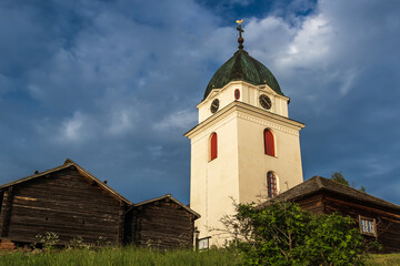 Fototapeta na wymiar church and wooden cabins in the Swedish countryside