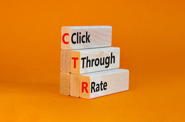 CTR click through rate symbol. Wooden blocks with words 'CTR click through rate'. Beautiful orange background. Business and CTR click through rate concept. Copy space.