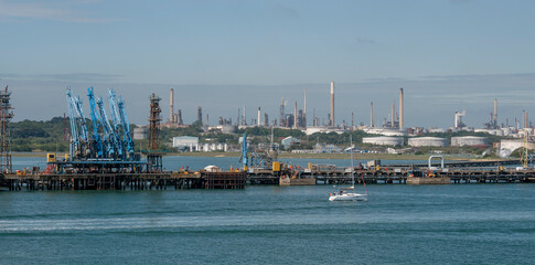 England, UK. 2021.  Fuel loading jetty at a refinery with a background of fuel storage tanks.