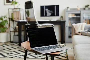 Close-up of laptop with empty screen on the chair in the room for online work