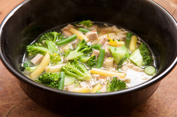 High angle shot of local homemade chicken pho with farm fresh vegetables and ramen noodles