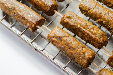 Minced and shaped lamb kebabs with chilli and coriander prepared for grill