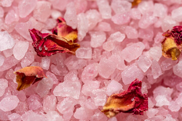 Macro salt crystals with crushed flower petals. Bath salt. Blurry background and shallow depth of field.
