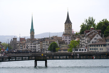 Obraz premium View over the old town of Zurich with churches Fraumünster (German, translation is Women's Minster), and St. Peter at summer day. Photo taken June 20th, 2021, Zurich, Switzerland.
