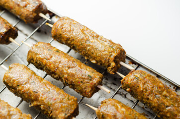 Minced and shaped lamb kebabs with chilli and coriander prepared for grill