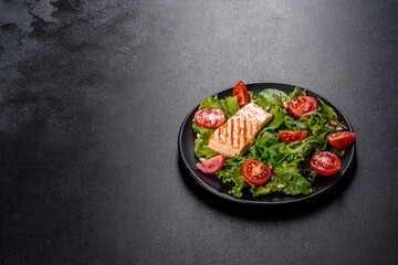 Delicious fresh salad with fish, tomatoes and lettuce leaves