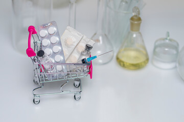 shopping trolley with pills, on white background