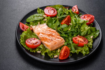 Delicious fresh salad with fish, tomatoes and lettuce leaves
