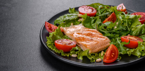 Delicious fresh salad with fish, tomatoes and lettuce leaves