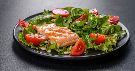 Delicious fresh salad with fish, tomatoes and lettuce leaves
