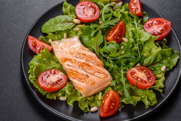Delicious fresh salad with fish, tomatoes and lettuce leaves