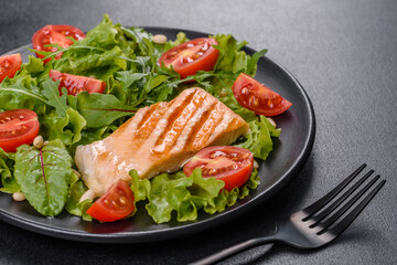 Delicious fresh salad with fish, tomatoes and lettuce leaves