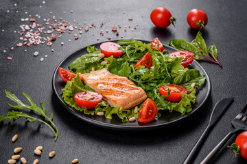 Delicious fresh salad with fish, tomatoes and lettuce leaves