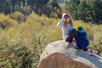 Naklejka na ściany i meble woman with a backpack hiking enjoying a relaxed hike