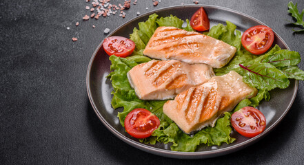 Delicious fresh salad with fish, tomatoes and lettuce leaves