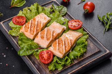 Delicious fresh salad with fish, tomatoes and lettuce leaves