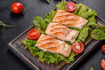 Delicious fresh salad with fish, tomatoes and lettuce leaves