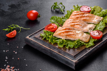 Delicious fresh salad with fish, tomatoes and lettuce leaves