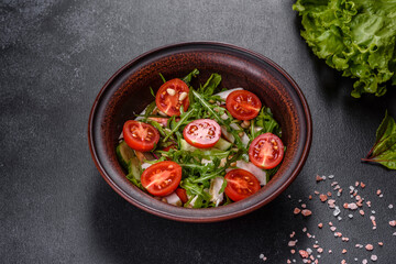 Pieces of chicken, tomatoes and lettuce leaves on a dark concrete background