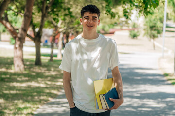 teenage student with books on campus or college