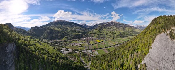180 panorama with beautiful mountains, sky, colorfull flowerfields and forest located in the alps of switzerland