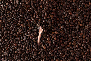 A hand sending a greeting from roasted coffee. Flat lay. Drink concept