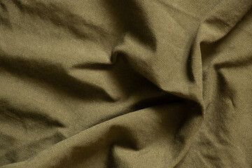dark green crumpled fabric as background, fabric