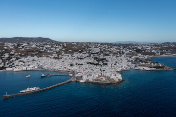 Greece, Mikonos island, Cyclades. Aerial drone view. Mikonos Chora whitewashed buildings cityscape, port and coastline.