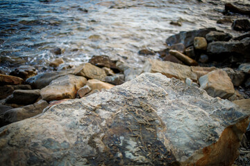 Fototapeta na wymiar Seascape, huge stones in the sandy tidal waves.