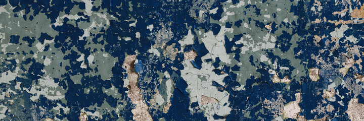 Peeling paint on the wall. Panorama of a concrete wall with old cracked flaking paint. Weathered rough painted surface with patterns of cracks and peeling. Wide panoramic grunge texture for background