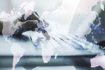 Abstract creative digital world map and hands typing on laptop on background, globalization concept. Multiexposure