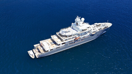 Aerial drone photo of luxury yacht anchored in Mediterranean destination island with deep blue sea