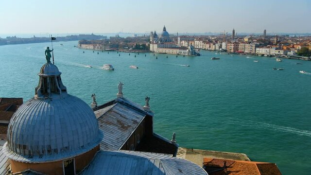 Giudecca Canal - Aerial panoramic view of Giudecca Canal, with Basilica of Santa Maria della Salute towering at Punta della Dogana. Venice, Veneto, Italy.