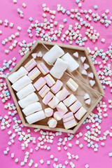  Variety Marshmallows charcuterie board on pink background. Close up, top view.