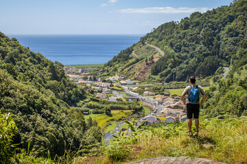 Fototapeta na wymiar Hiker enjoying view to Atlantic ocean, Azores travel destination, nature.