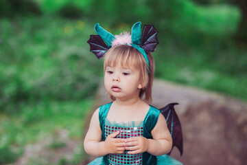 adorable baby in a dragon costume in the garden